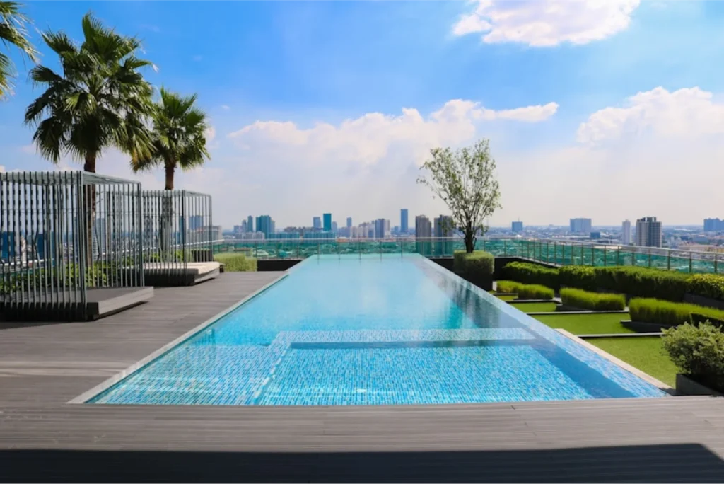 Rooftop swimming pool enclosed by glass and steel safety fencing